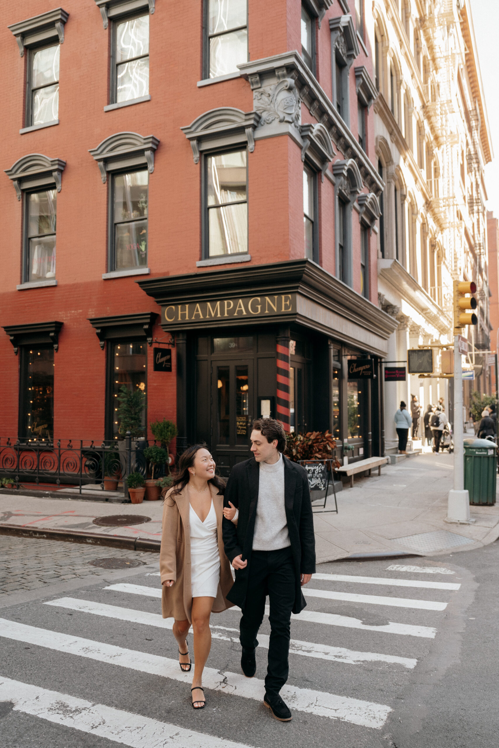 Man and Woman walking in SOHO during their engagement session.
