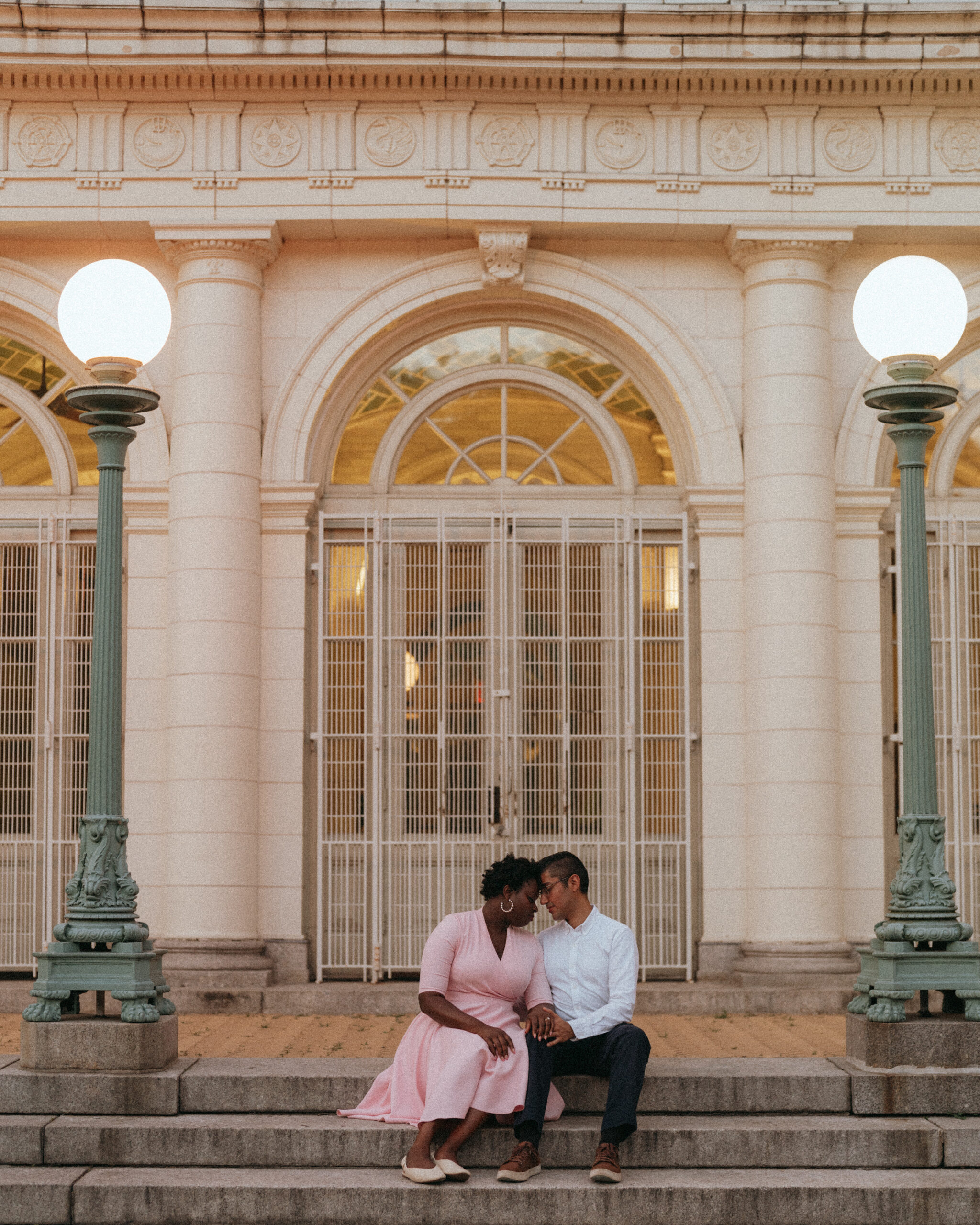 Couple kissing on the steps of the boat house at Prospect Park in Brooklyn, NYC.