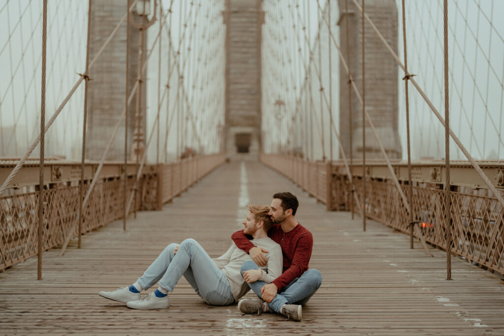 Couple hugging on the Brooklyn Bridge.