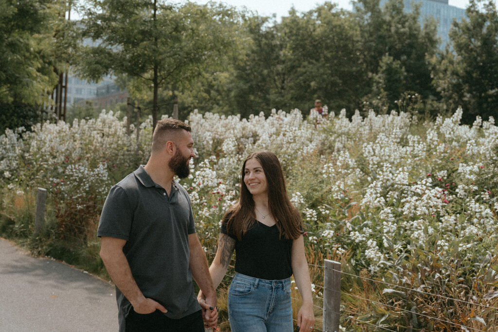 Couple looking at each other and holding hands at the Brooklyn Botanical Gardens.