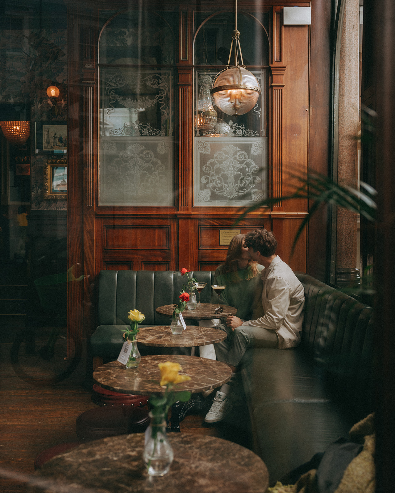 Couple kissing in cafe.