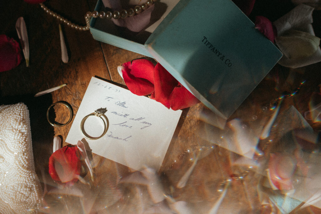 Close up photo of bride's ring and a note.