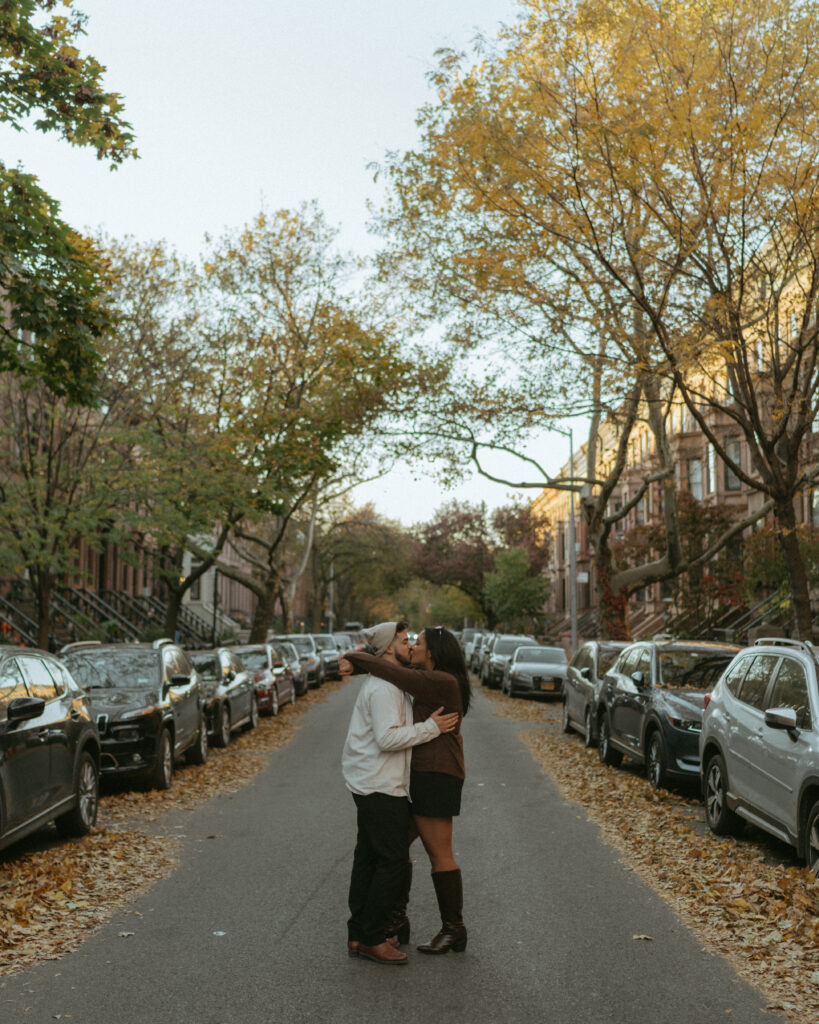 Couple kissing in the street in the neighborhood Park Slope in Brooklyn.
