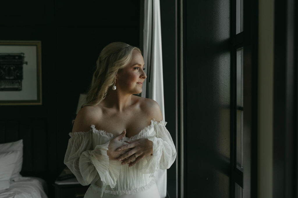 Bride looking out window and smiling