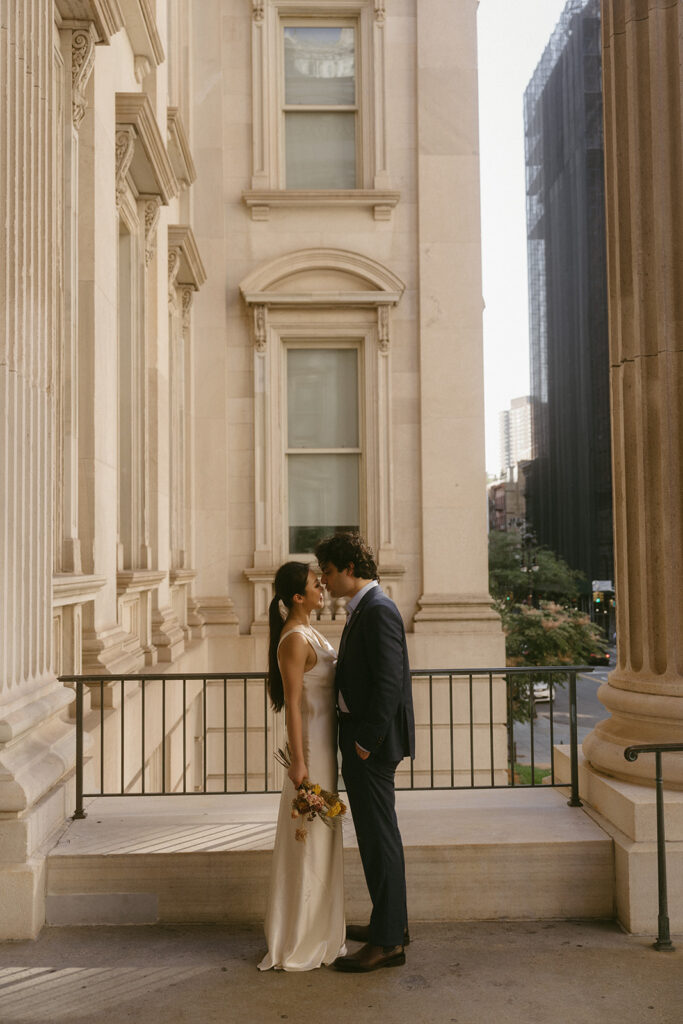 Couple kissing on City Hall steps in NYC.