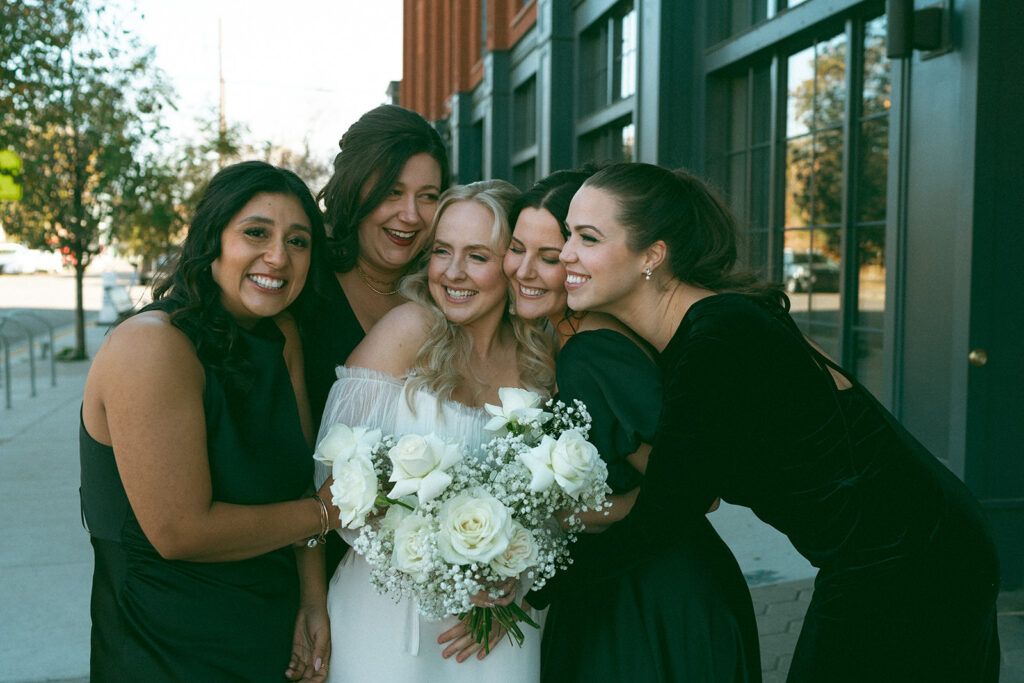 Bride and bridesmaids hugging