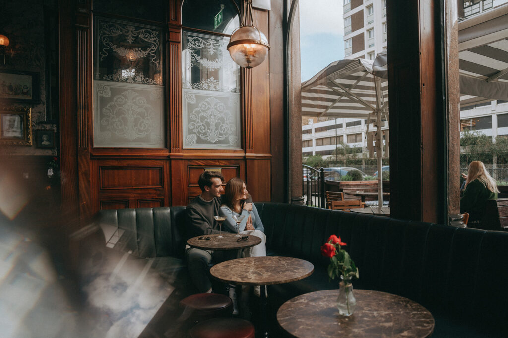 Couple looking out the window in a bar in London.