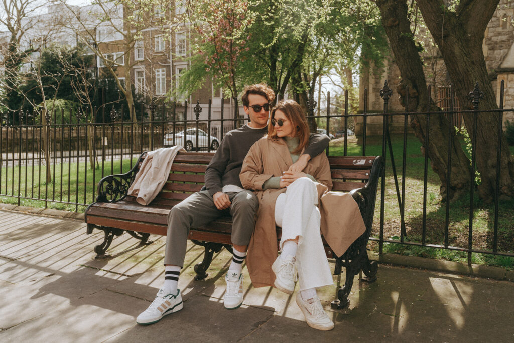 Couple sitting on bench in London.