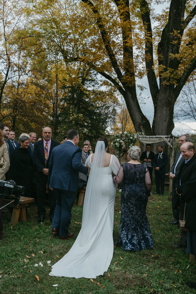 Bride walking down the aisle at her Blooming Hill Farm wedding outdoor ceremony