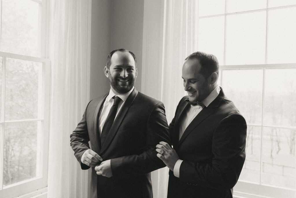 Groom and best man getting ready at the Peach Grove House for a Blooming Hill Farm wedding.