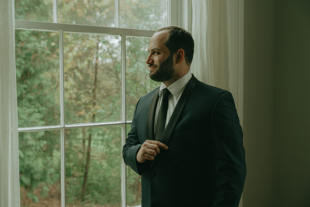 Groom getting ready at the Peach Grove House for a Blooming Hill Farm wedding.