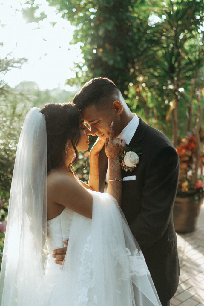 A sweet forehead-to-forehead moment between the bride and groom during their Indian Catholic wedding at one of the most stunning Indian wedding venues in Long Island, captured by Elsie Goodman Photography.
