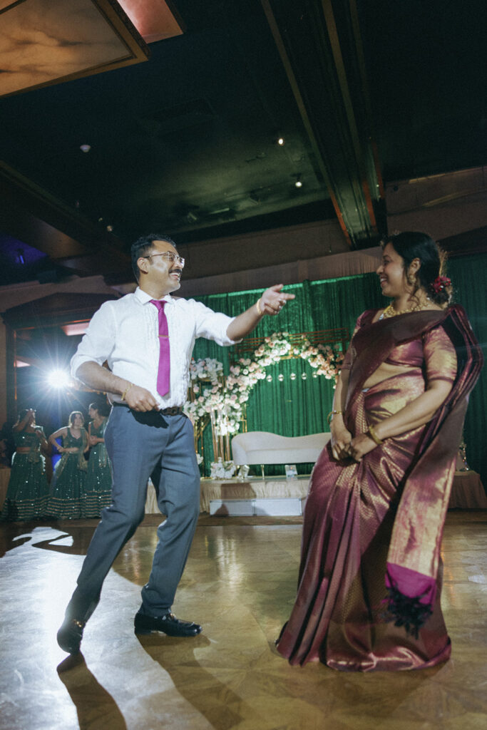 Fun parent dance moment during an Indian catholic wedding reception at Crest Hollow Country Club, highlighting family traditions at one of Long Island’s favorite Indian wedding venues, captured by Elsie Goodman Photography.