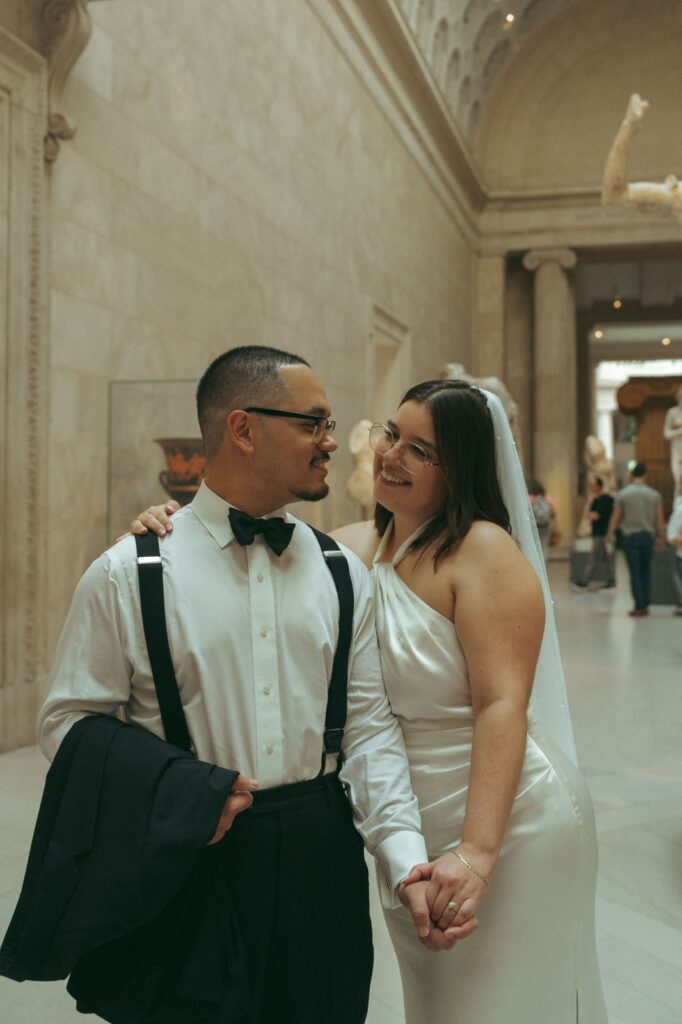 Couple poses together at the MET after their New York Public Library elopement, photographed by Elsie Goodman.