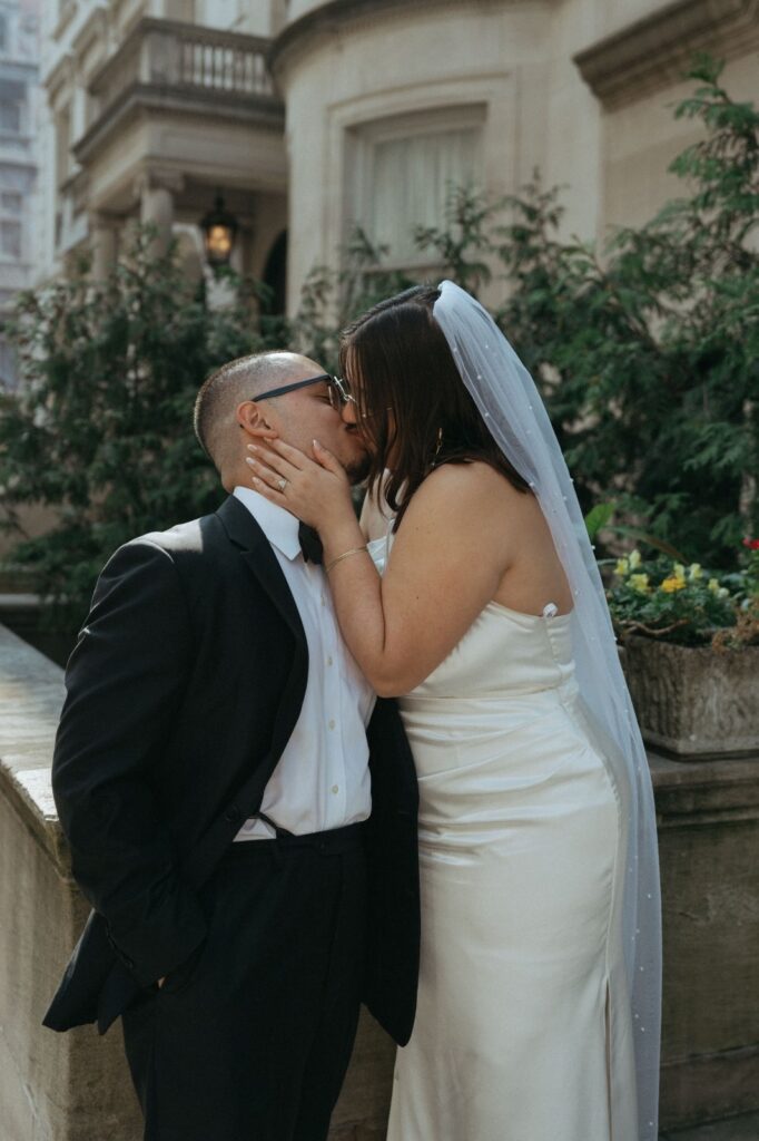 Bride and groom portrait kissing in NYC after eloping, shot by Elsie Goodman Photography.