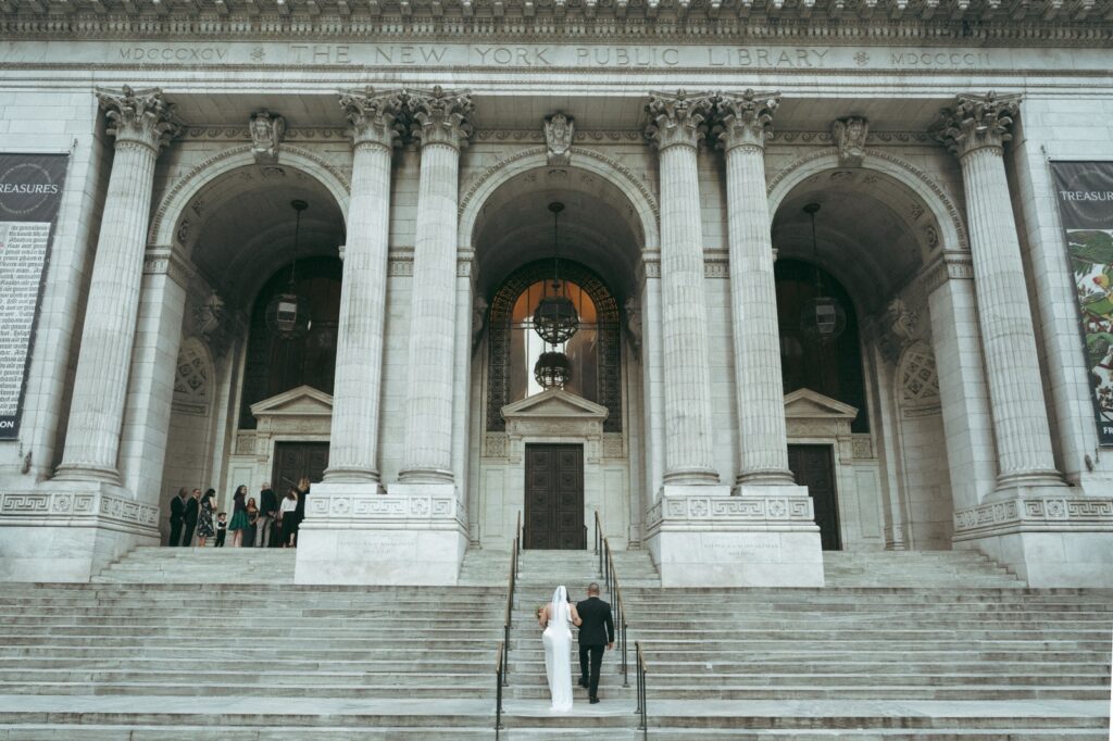 Bride and her father climb the grand steps of the New York Public Library for their elopement, photo by Elsie Goodman.