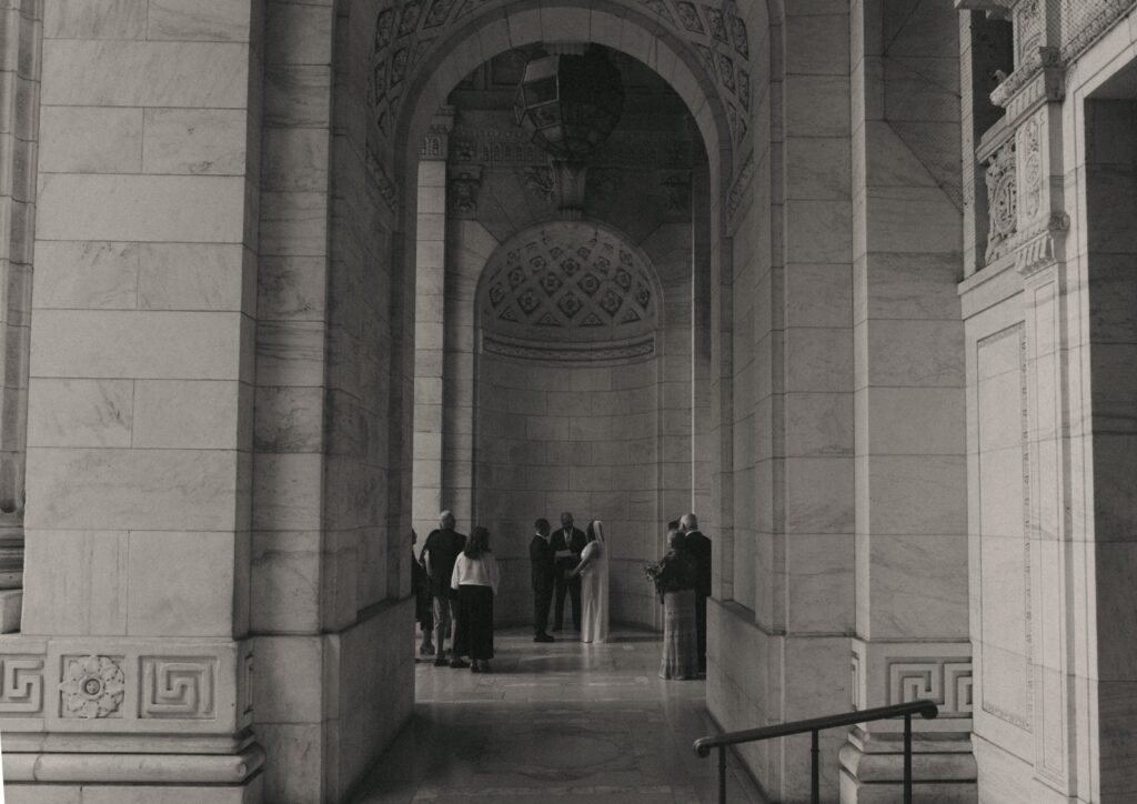 Black and white photo of intimate NYPL wedding ceremony, by Elsie Goodman.