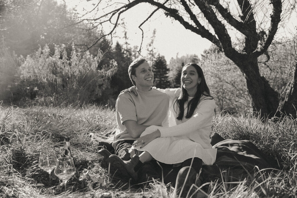 Black and white engagement photo in Vermont of the couple laughing, by Elsie Goodman Photography.