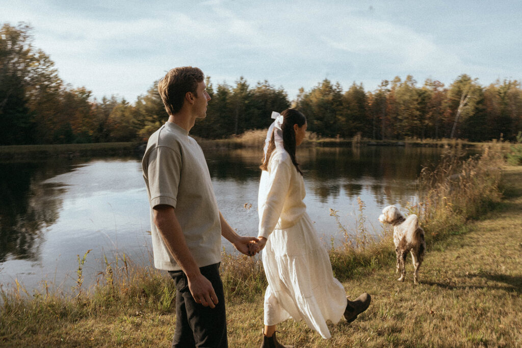 Vermont couples photos walking with dog by lake, by Elsie Goodman Photography.
