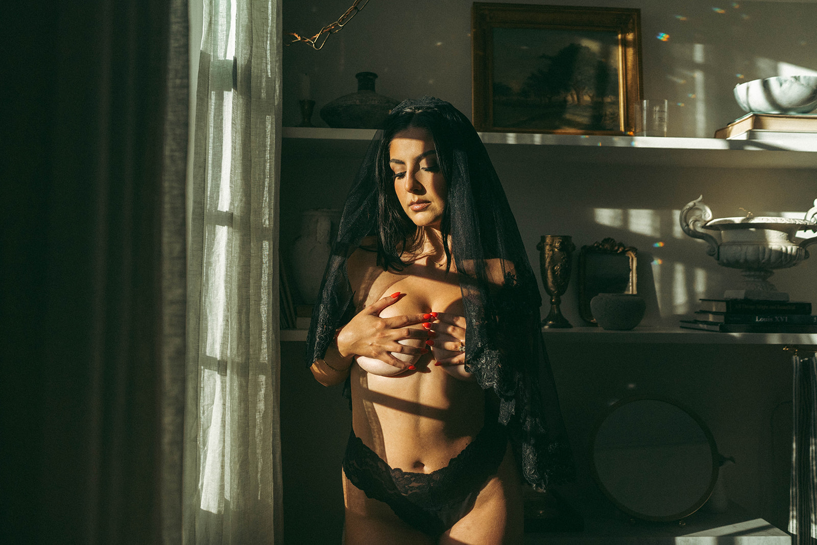 Bridal boudoir photoshoot at home with woman wearing lace lingerie and black veil in golden light, shot by Elsie Goodman Photography.