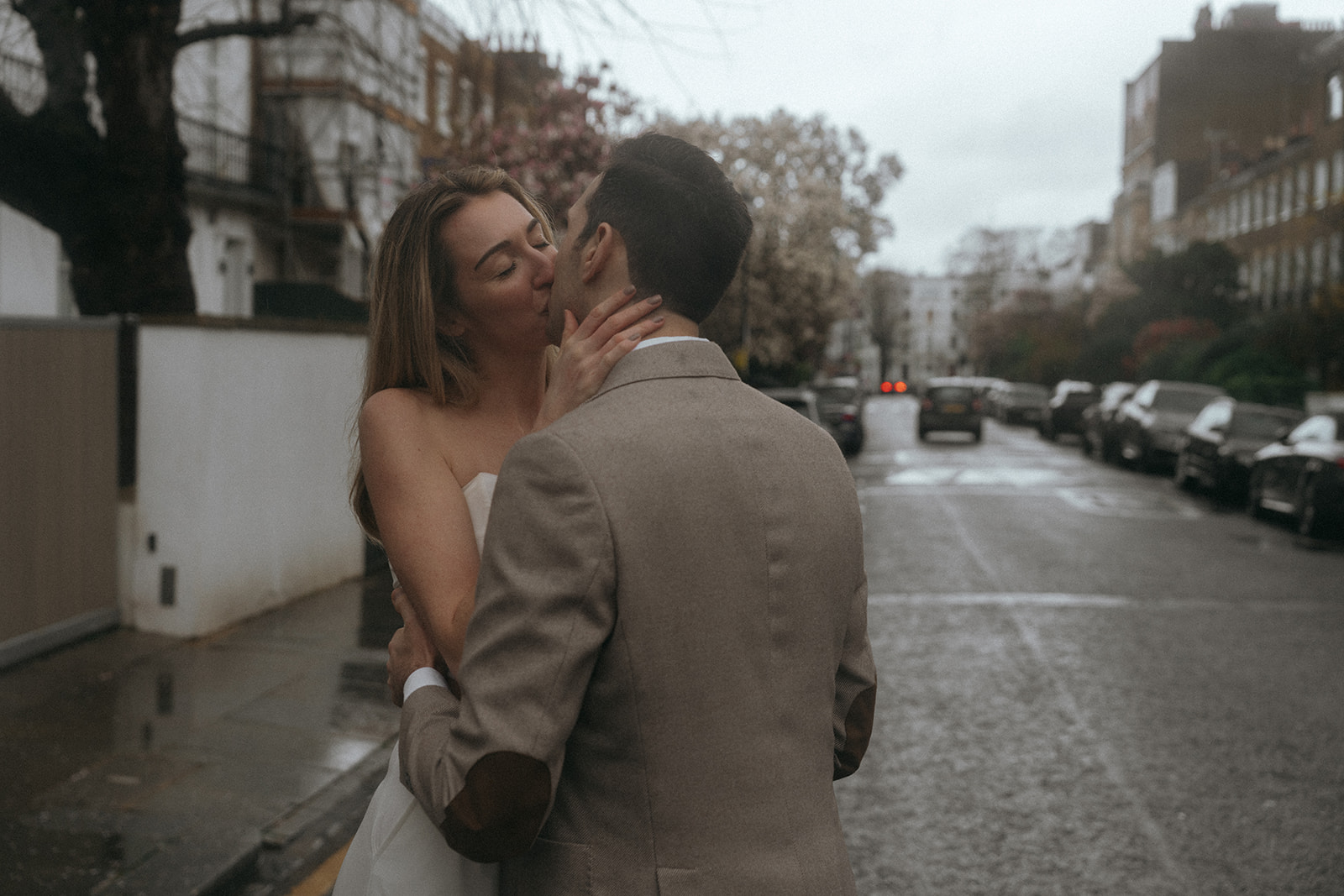 Man and women kiss on a London street, shot by London engagement photographer Elsie Goodman.