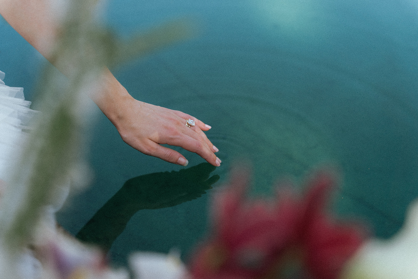 Viscaya Close up of a bride's hand with her wedding rings, lightly touching the water by Vizcaya Wedding Photographer Elsie Goodman.