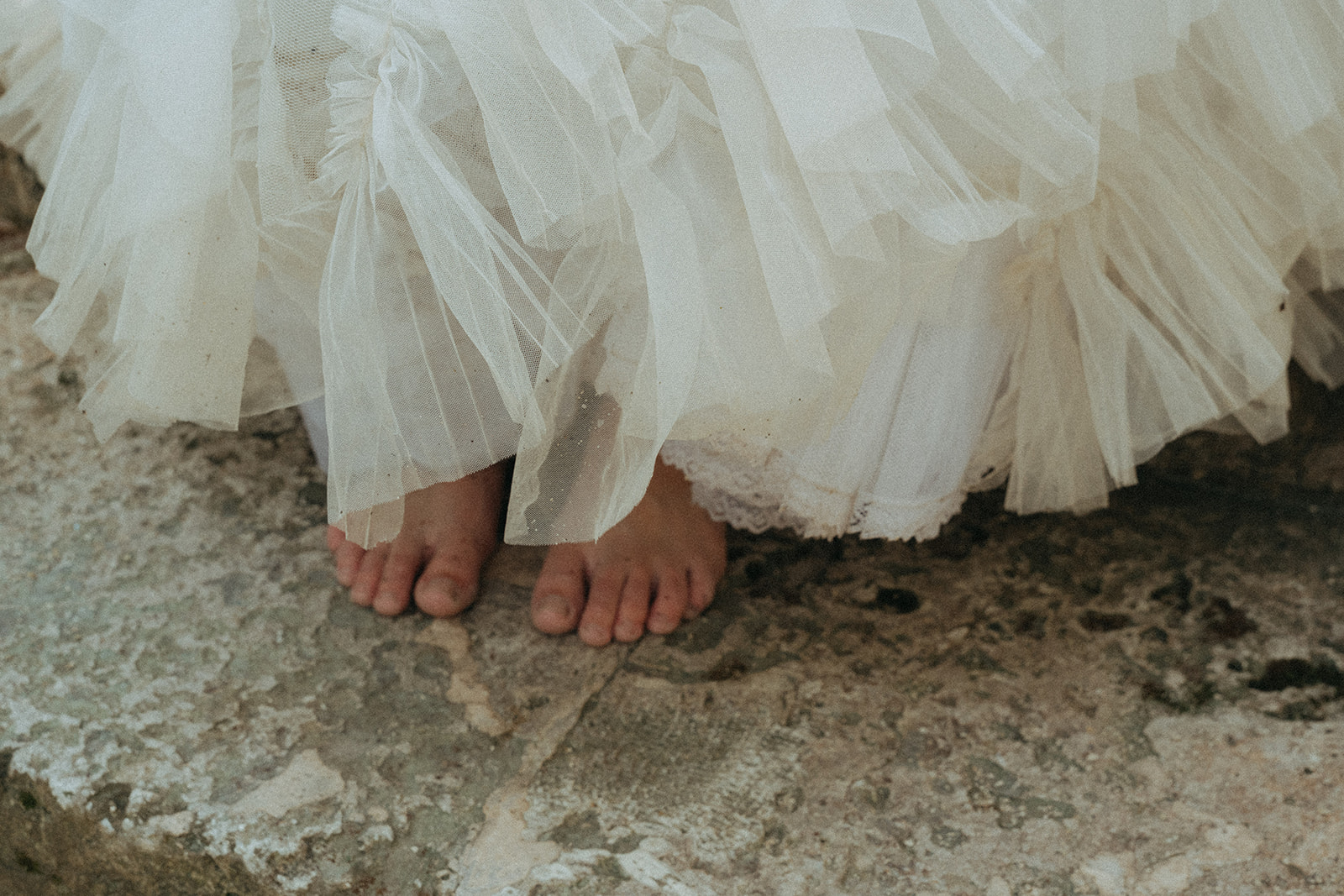 Viscaya Close-up of the brides gown with her bare feet showing, by Vizcaya Wedding Photographer Elsie Goodman.