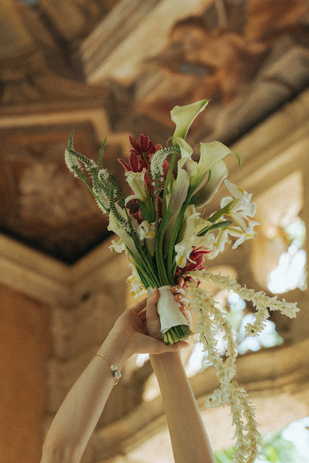 Viscaya Bride with her arm in the air, shows off her bridal bouquet by Vizcaya Wedding Photographer Elsie Goodman.
