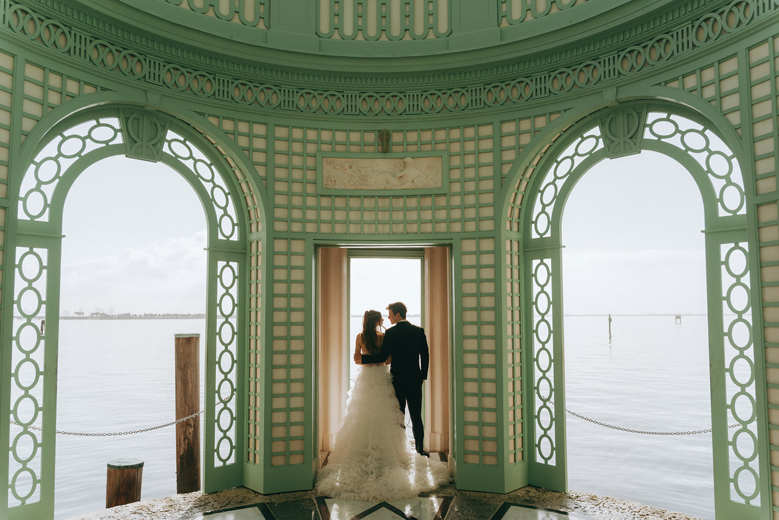 Viscaya Bride and groom look out over the ocean in the gazebo by Vizcaya Wedding Photographer Elsie Goodman.