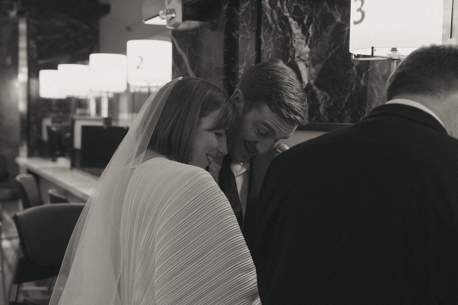 Rachel and Dave’s 2 day celebration Black and white photos of a bride and groom leaning in close smiling by NYC city hall wedding photographer Elsie Goodman.