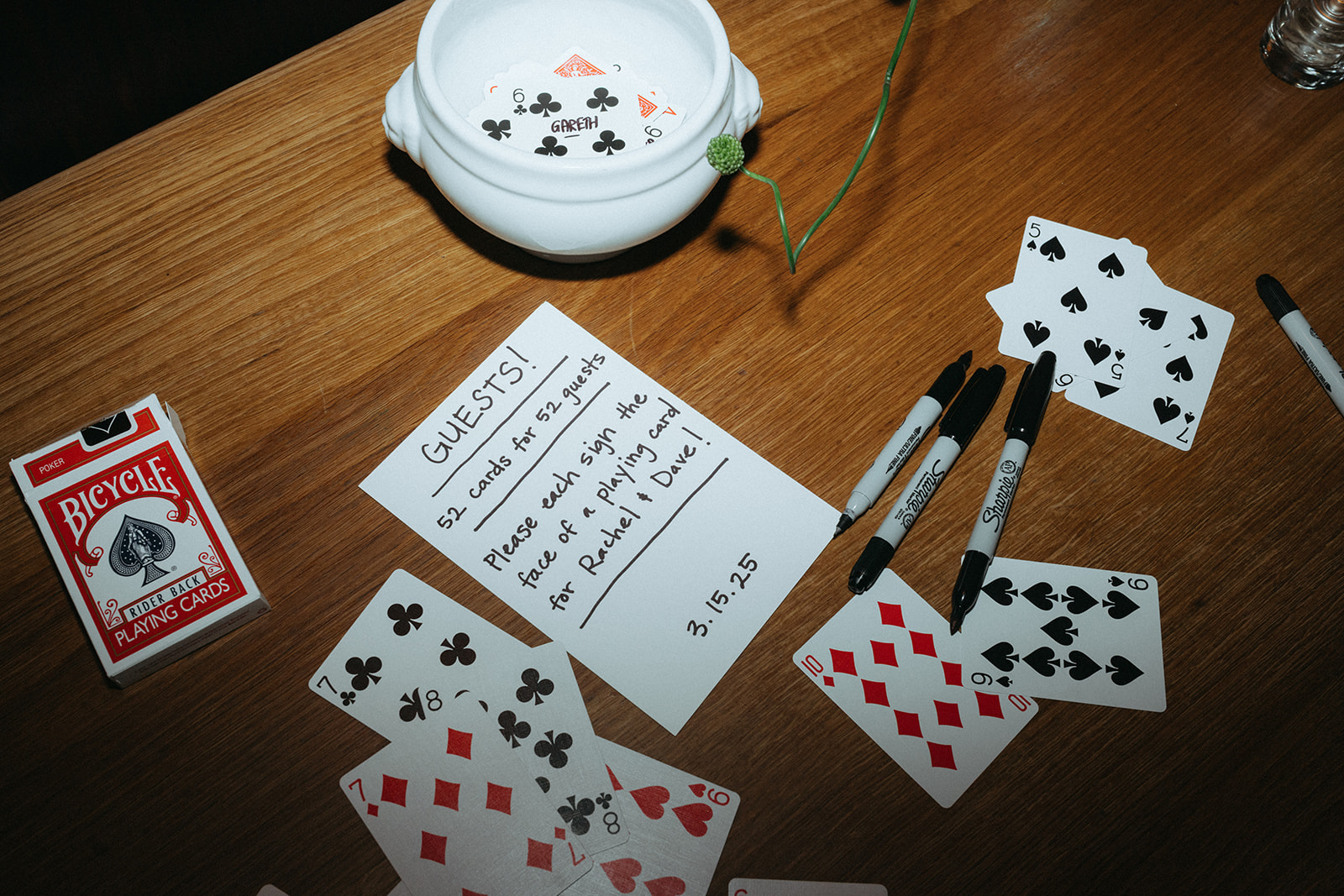 Rachel and Dave’s 2 day celebration Guest book and instructions, which read to write on one card from the deck signs her guest book, which is a deck of cards at Franks restaurant in NYC by NYC elopement photographer Elsie Goodman.