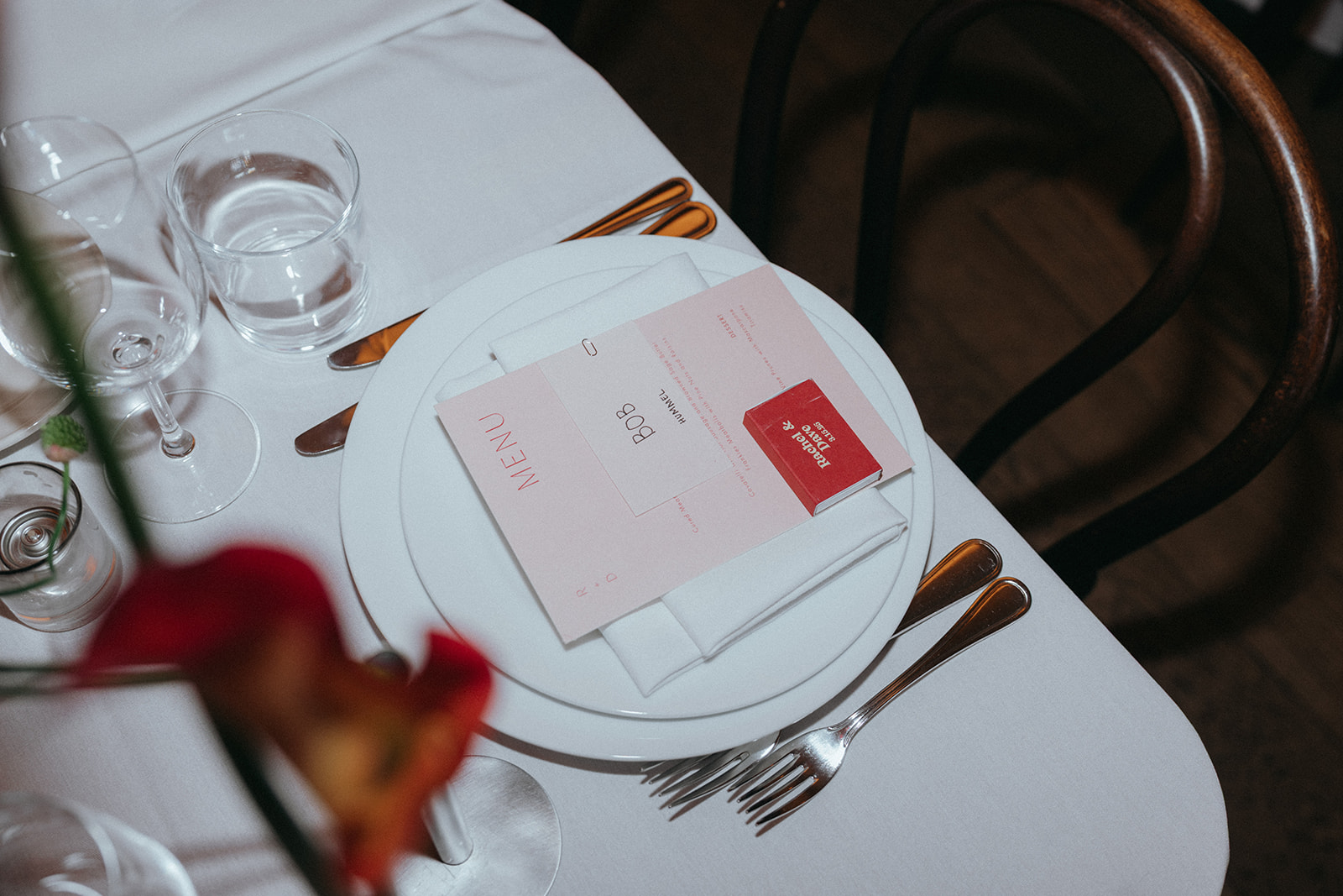 Rachel and Dave’s 2 day celebration plate setting for the wedding dinner and reception at Franks in NYC signs her guest book, which is a deck of cards at Franks restaurant in NYC by NYC elopement photographer Elsie Goodman.