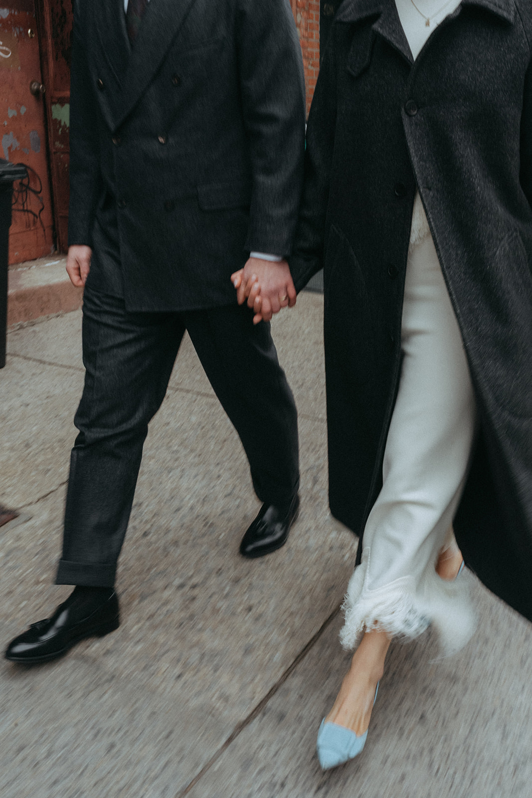 Rachel and Dave’s 2 day celebration Action shot of the bride and groom walking, holding hands by NYC elopement photographer Elsie Goodman.