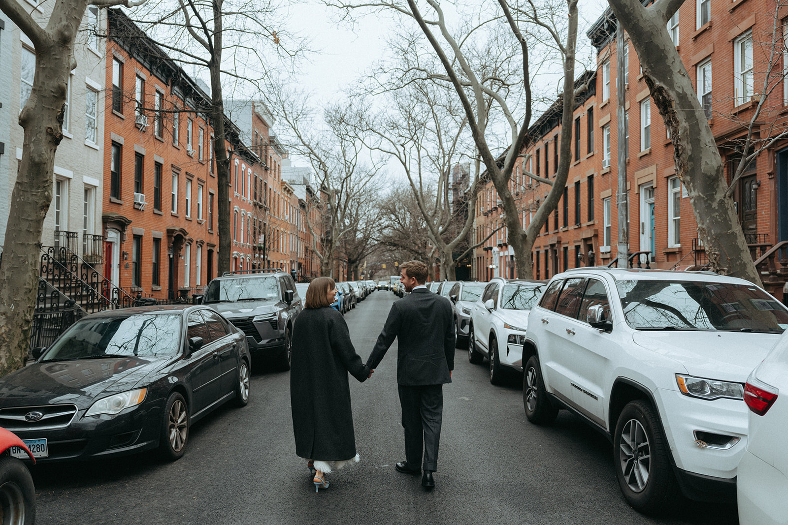 Rachel and Dave’s 2 day celebration Bride and groom walking down a city street by NYC elopement photographer Elsie Goodman.