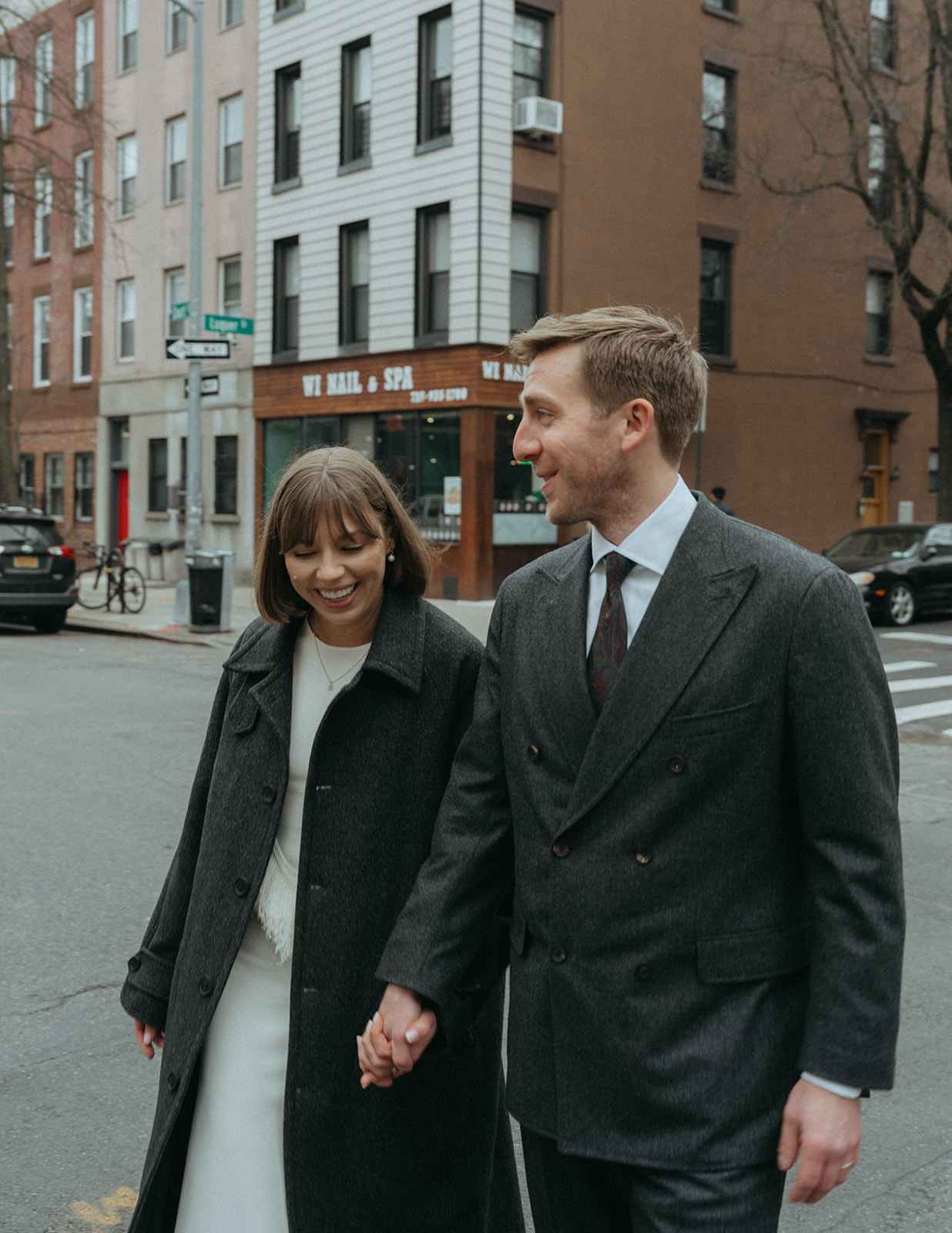 Rachel and Dave’s 2 day celebration Bride and groom walking hand in hand to their reception by elopement photographer Elsie Goodman.