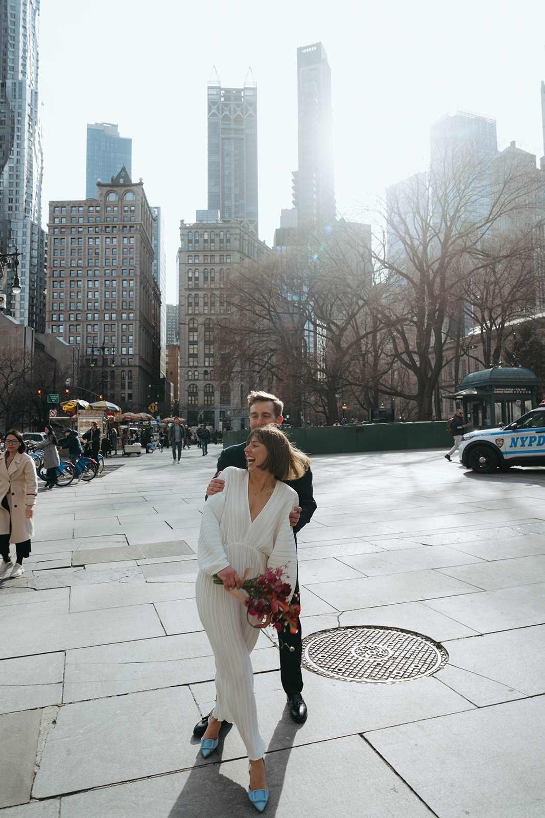 Rachel and Dave’s 2 day celebration Bride and groom laughing by NYC city hall wedding photographer Elsie Goodman.