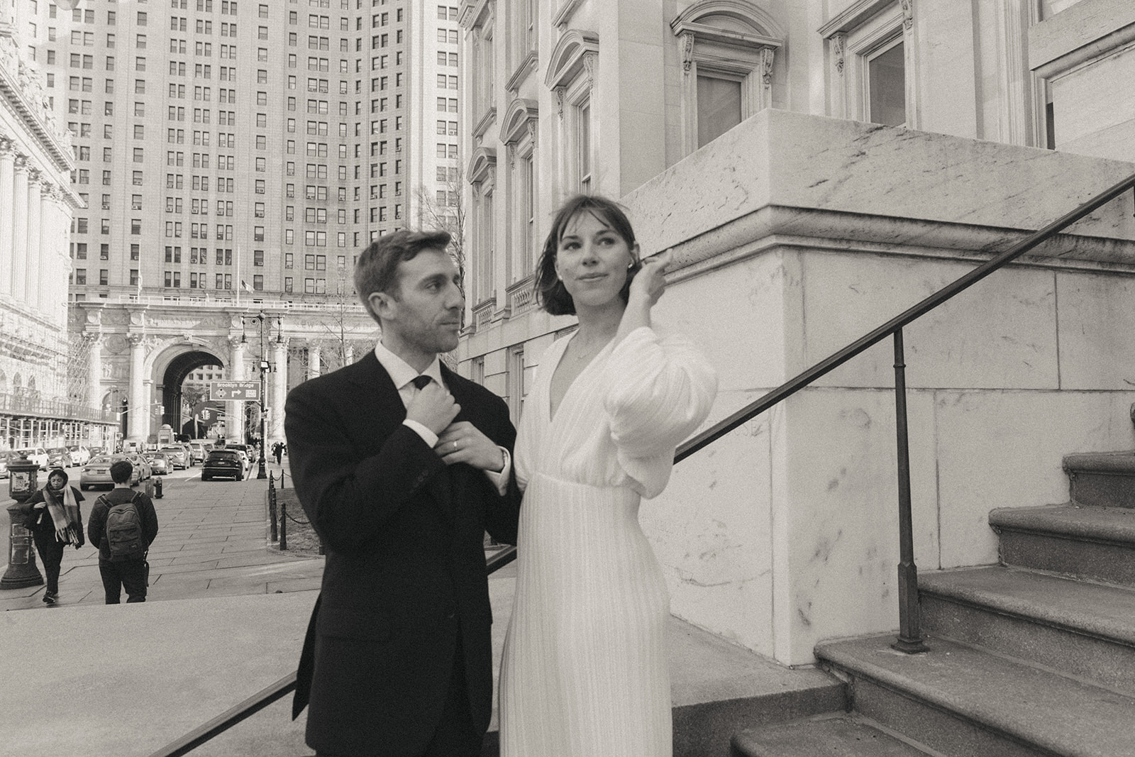 Rachel and Dave’s 2 day celebration B&W photo of the bride and groom outside of city hall Waist down shot of bride and groom walking down stairs, showing off her blue suede heels by NYC city hall wedding photographer Elsie Goodman.