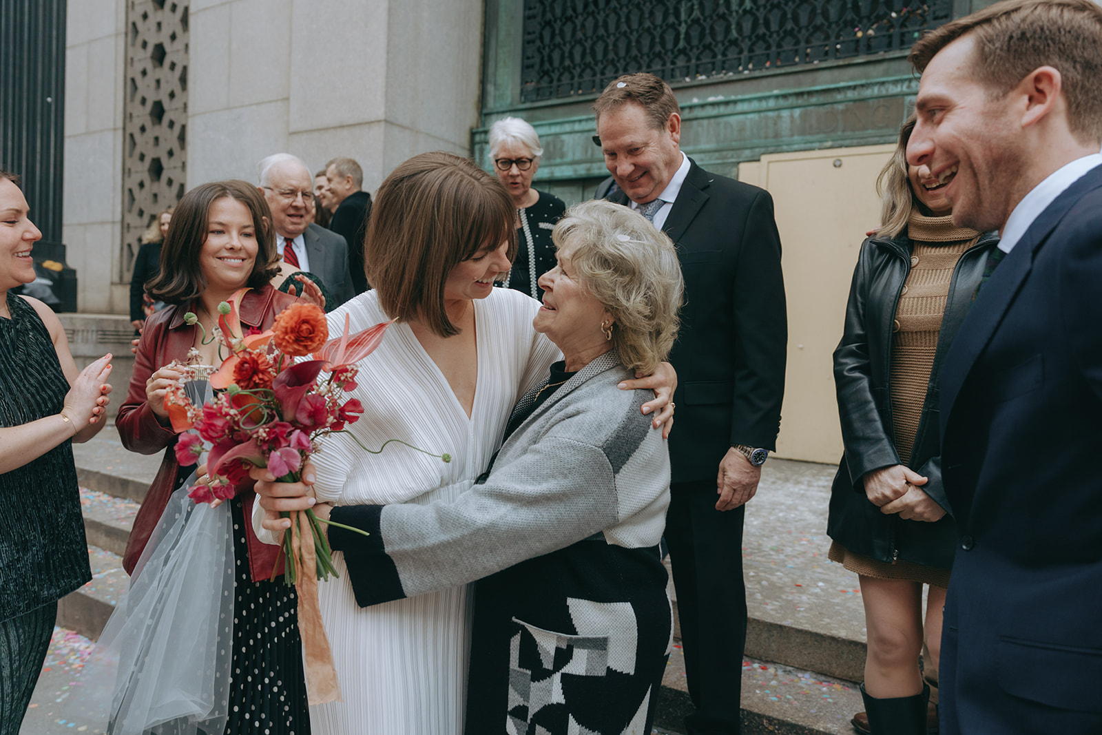 Rachel and Dave’s 2 day celebration Bride with her arm around her grandmother smiling, her bouquet in the other hand by NYC city hall wedding photographer Elsie Goodman.