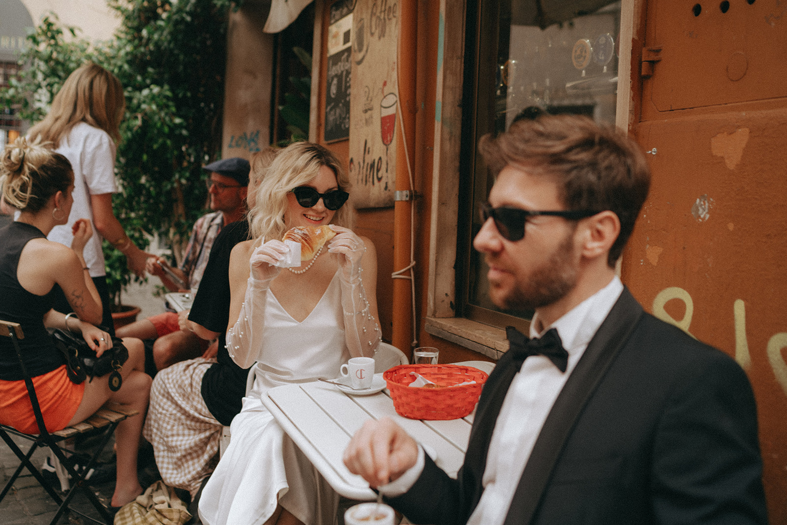Bride and groom having espresso in a Trastevere coffee shop after exchanging vows by Rome elopement photographer Elsie Goodman.