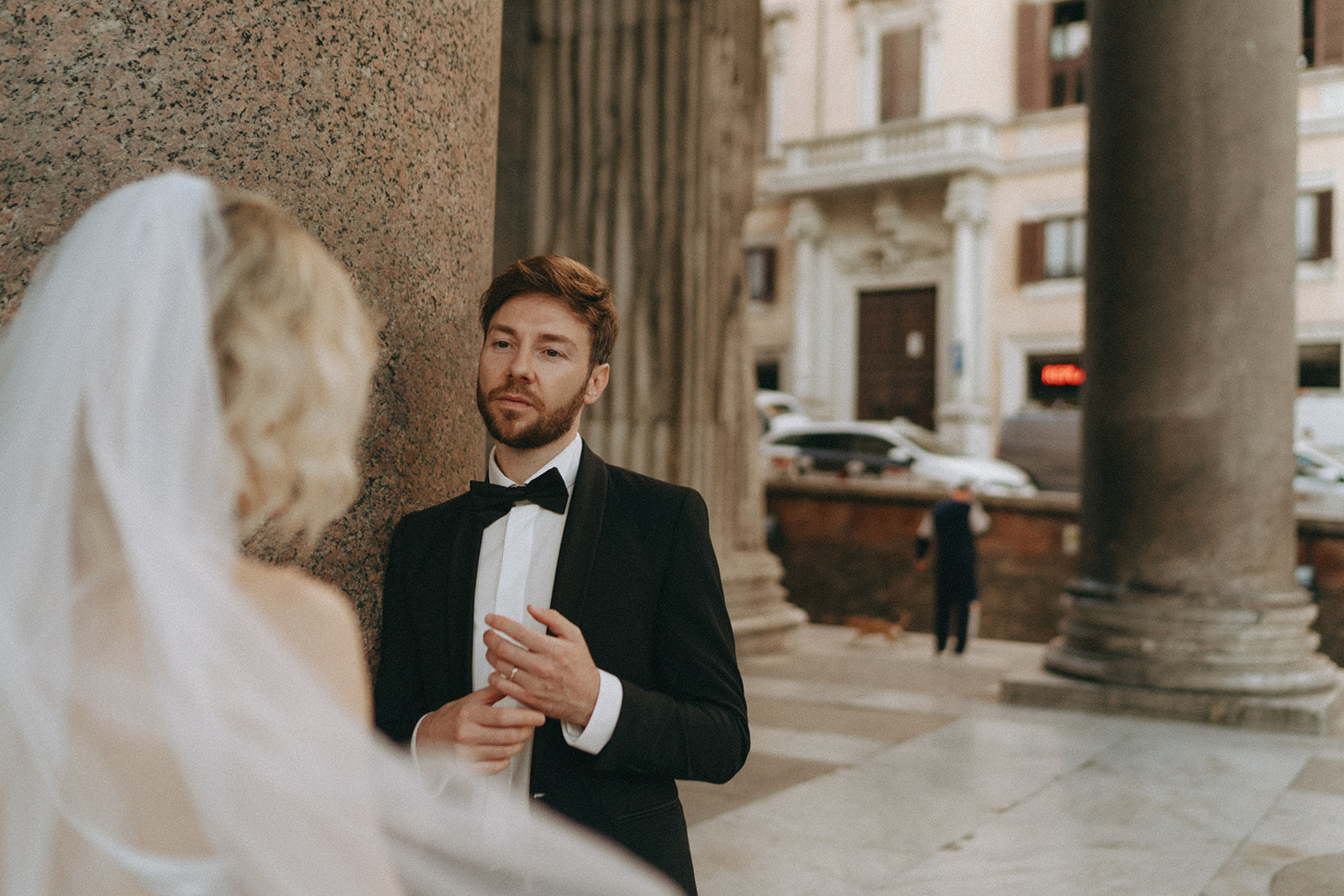 Bride and groom at under the columns of the Pantheon exchanging vows by Rome elopement photographer Elsie Goodman.