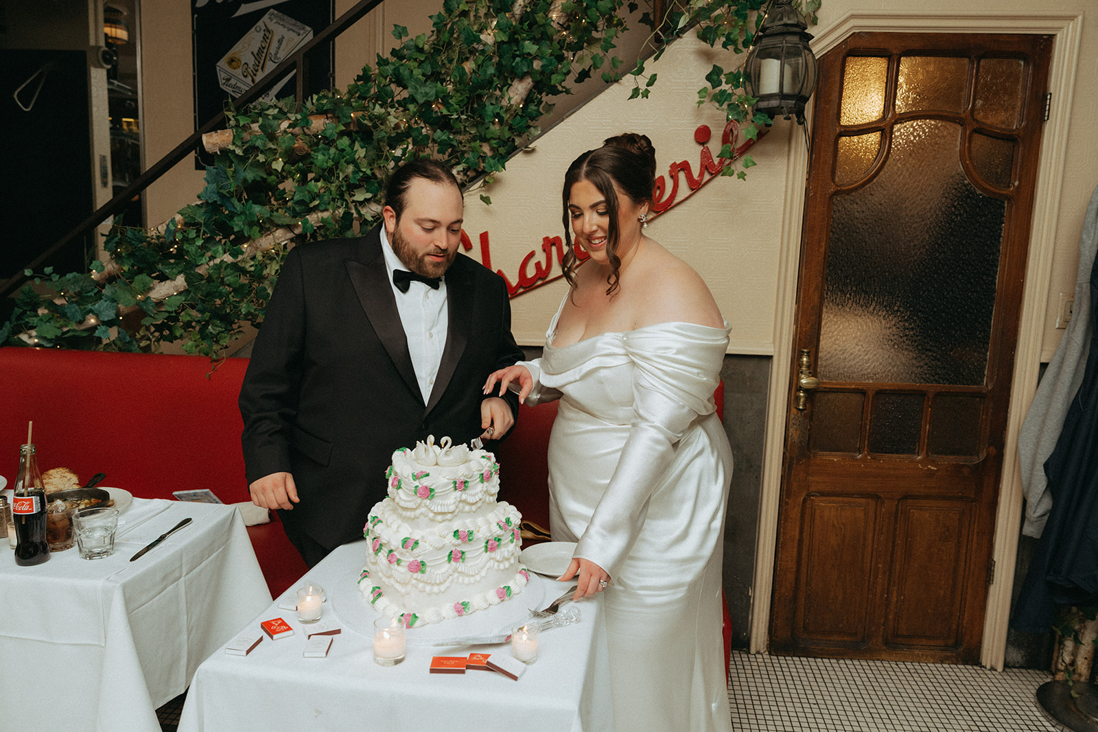 Madison + Dylan 620 Loft and Garden Wedding bride and groom cutting vintage tiered cake at wedding reception at Juliette’s in nyc, shot by elsie goodman, a destination and NYC wedding photographer