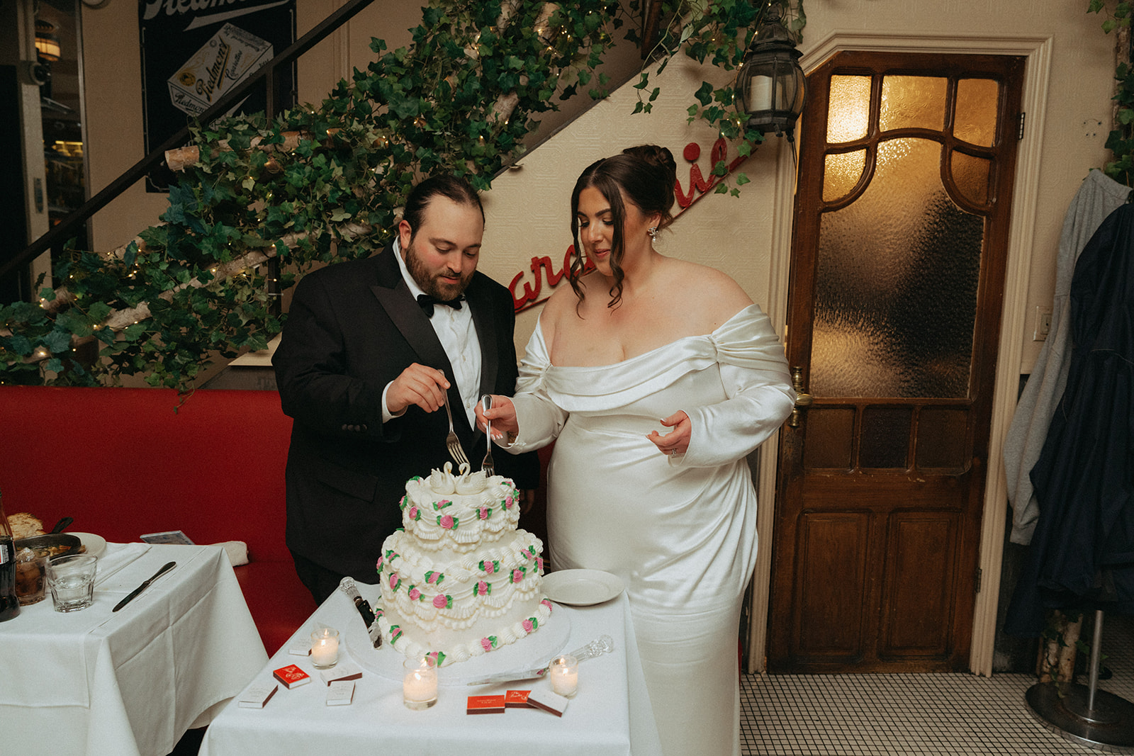 Madison + Dylan 620 Loft and Garden Wedding bride and groom tasting tiered vintage cake after 620 loft & garden wedding, shot by elsie goodman, a destination and NYC wedding photographer
