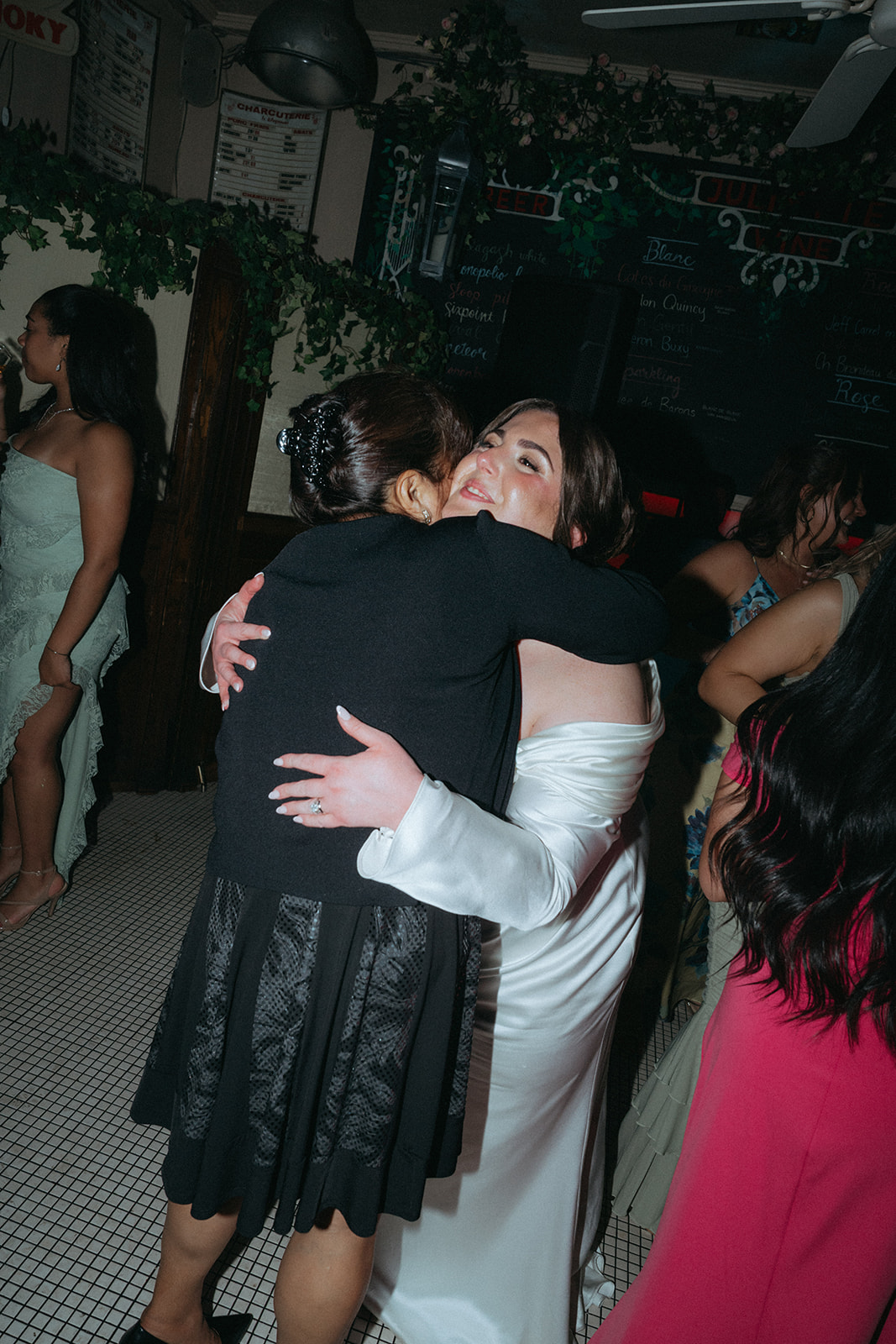 Madison + Dylan 620 Loft and Garden Wedding bride hugging loved one at wedding reception at Juliette’s in nyc, shot by elsie goodman, a destination and NYC wedding photographer