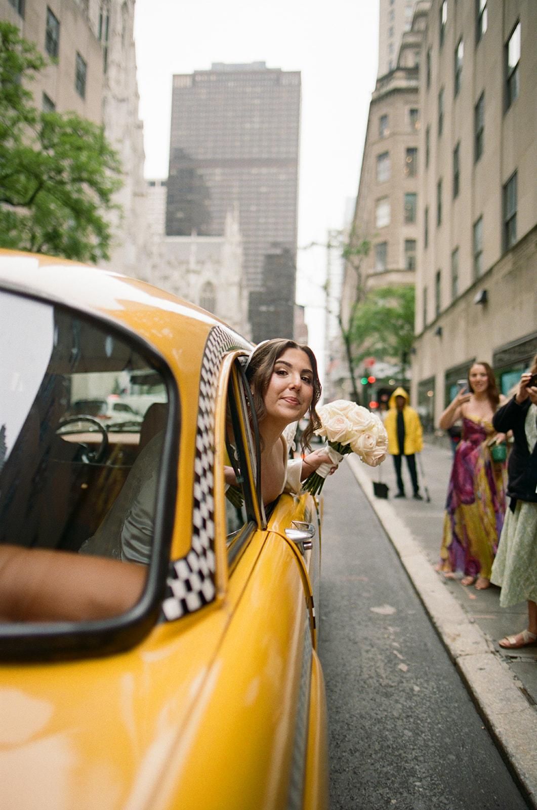 Madison + Dylan 620 Loft and Garden Wedding bride sticking head out of vintage taxi at 620 loft & garden wedding, shot by elsie goodman, a destination and NYC wedding photographer
