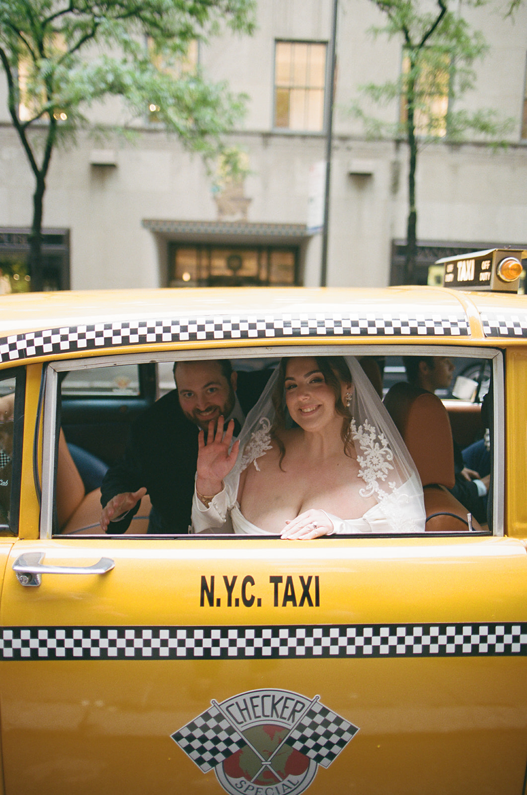 bride and groom leaving ceremony in vintage taxi at 620 loft & garden wedding, shot by elsie goodman, a destination and NYC wedding photographer