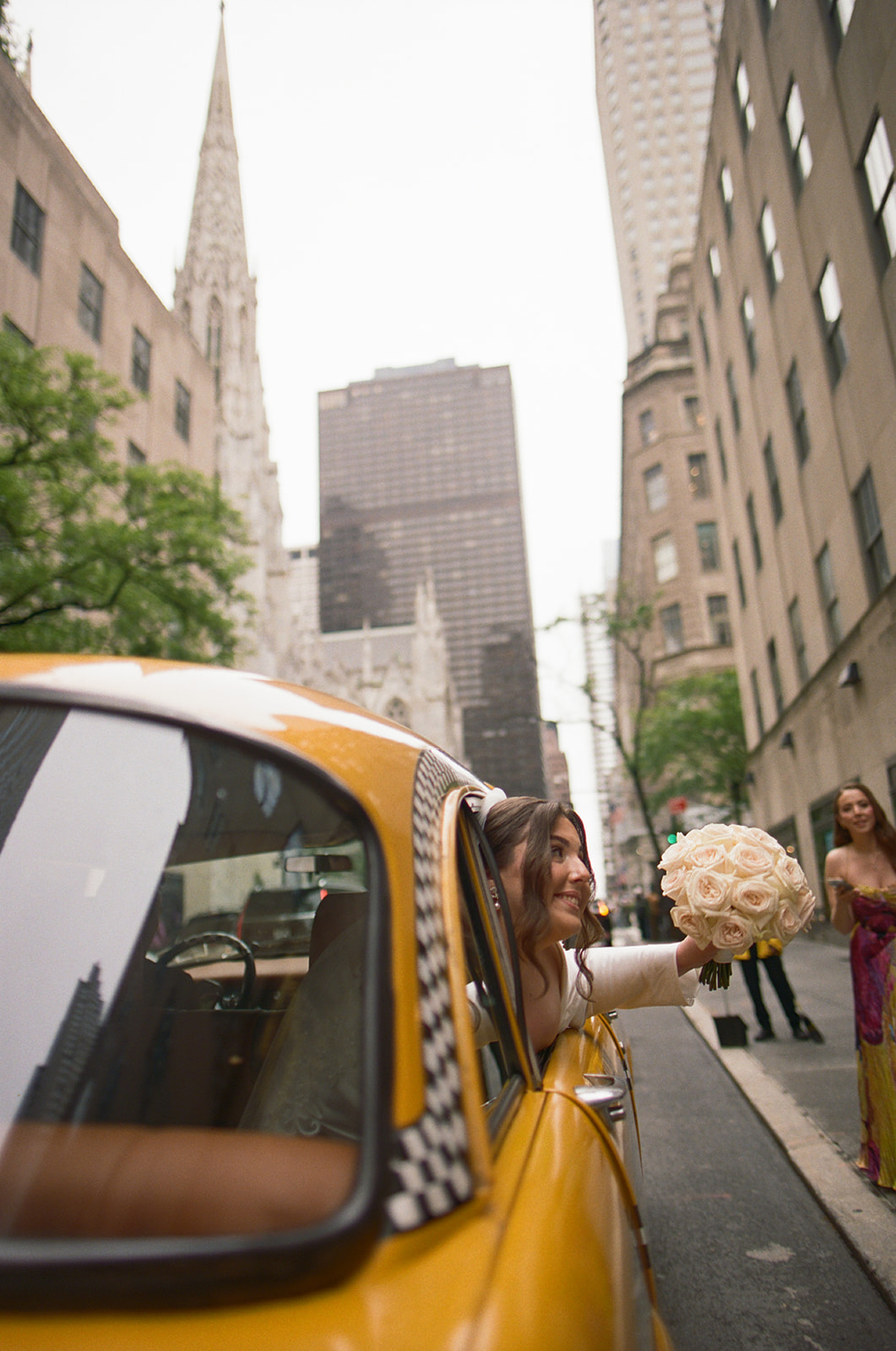 Madison + Dylan 620 Loft and Garden Wedding bride sticking head out window of vintage taxi after 620 loft & garden wedding, shot by elsie goodman, a destination and NYC wedding photographer