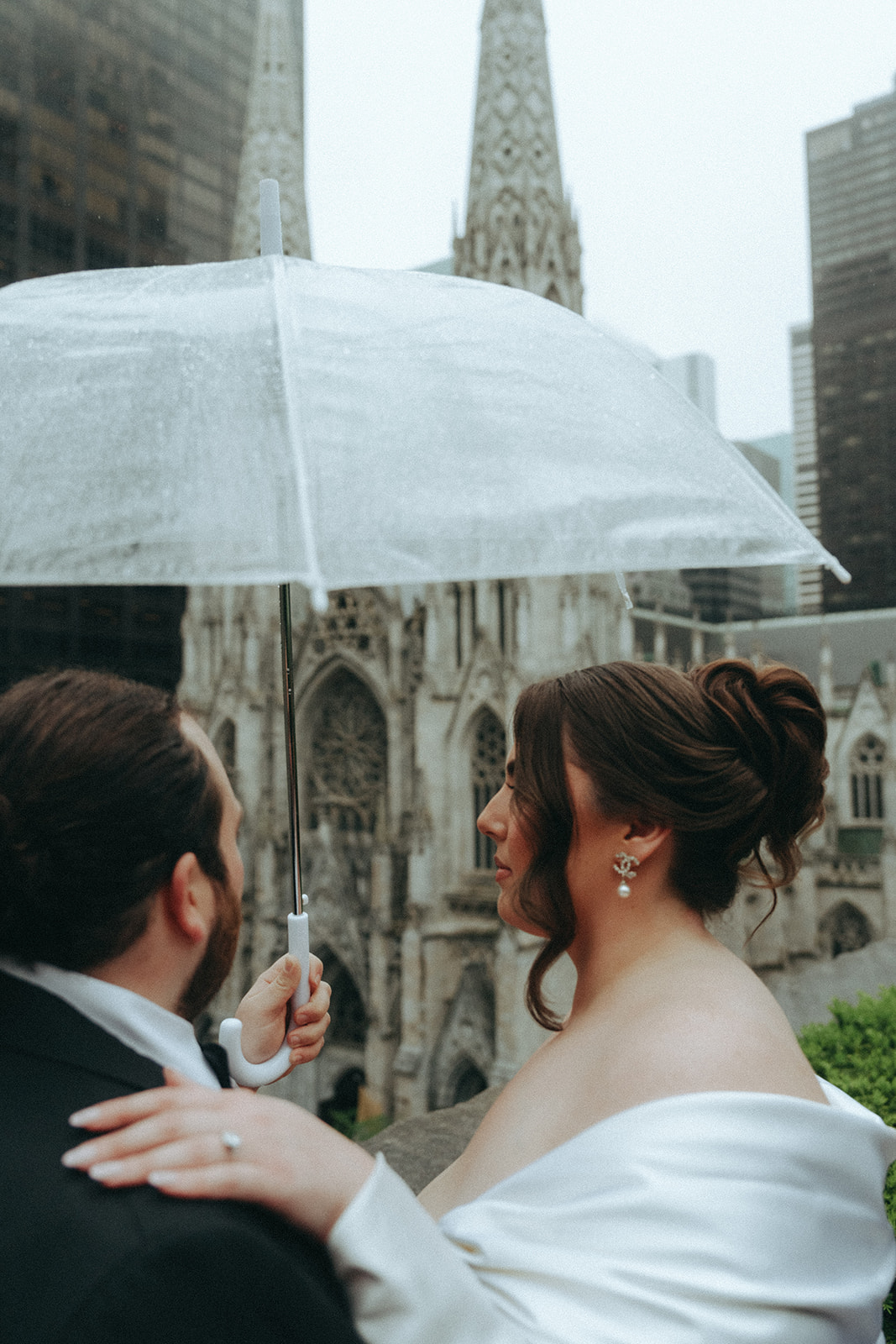 Madison + Dylan 620 Loft and Garden Wedding close up bride and groom portraits under a clear umbrella at 620 loft & garden wedding, shot by elsie goodman, a destination and NYC wedding photographer