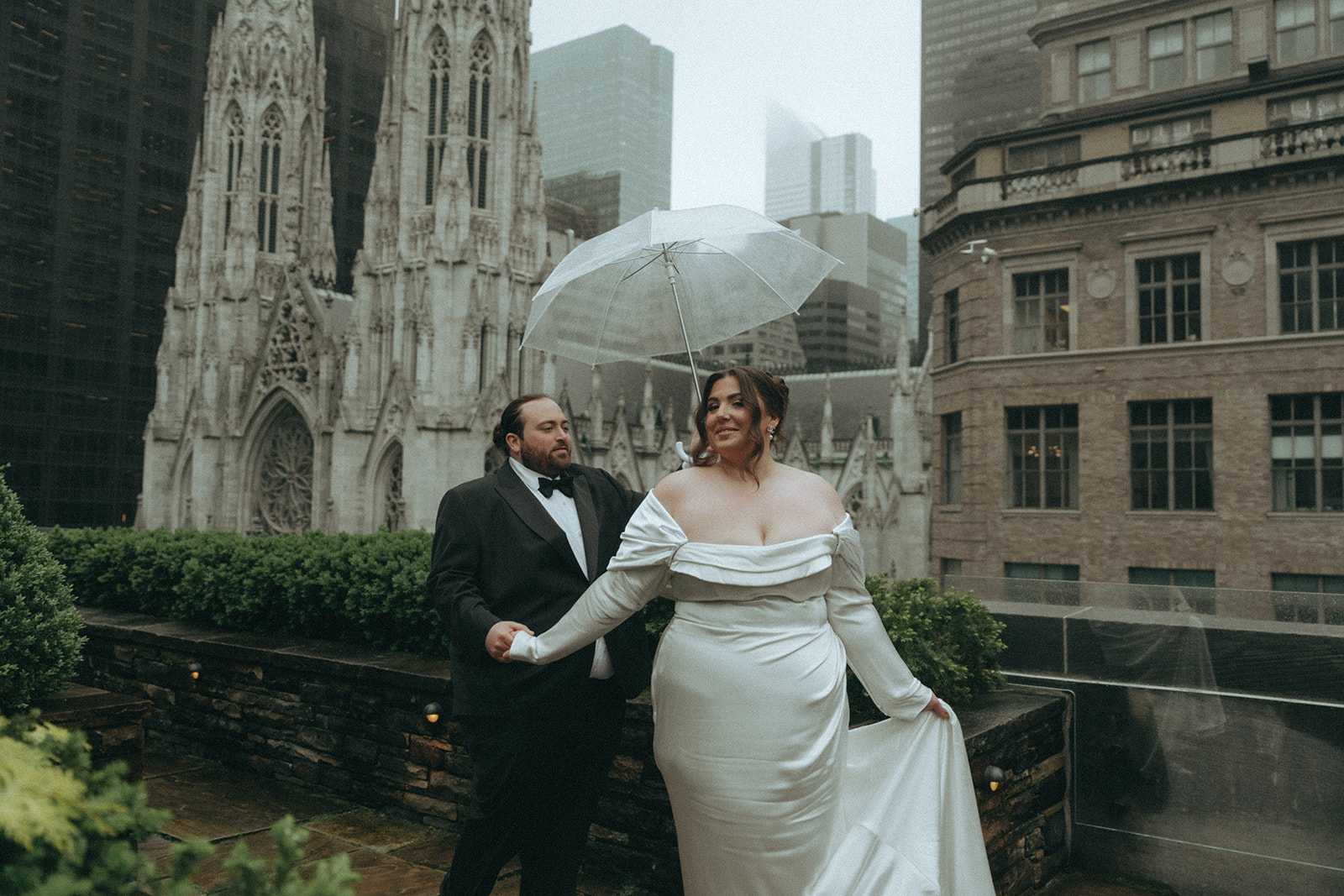 Madison + Dylan 620 Loft and Garden Wedding bride and groom posing on rooftop with umbrella at 620 loft & garden wedding, shot by elsie goodman, a destination and NYC wedding photographer