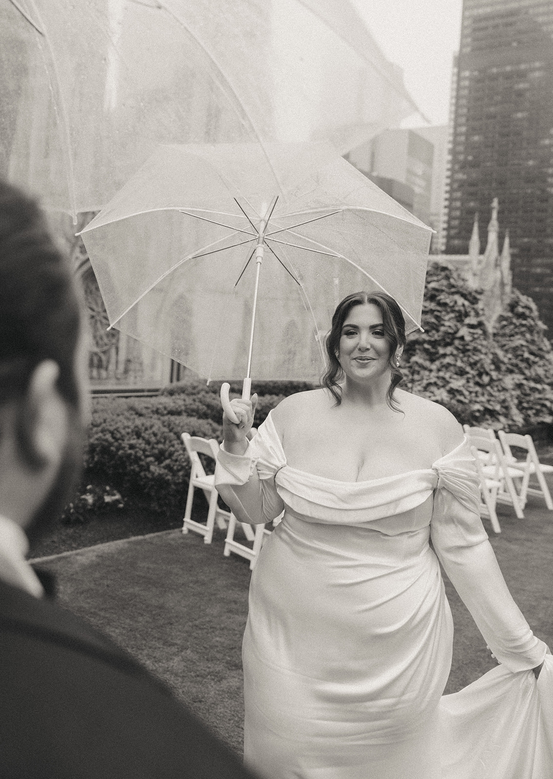 Madison + Dylan 620 Loft and Garden Wedding black and white photo of bride smiling at groom holding umbrella at 620 loft & garden wedding, shot by elsie goodman, a destination and NYC wedding photographer