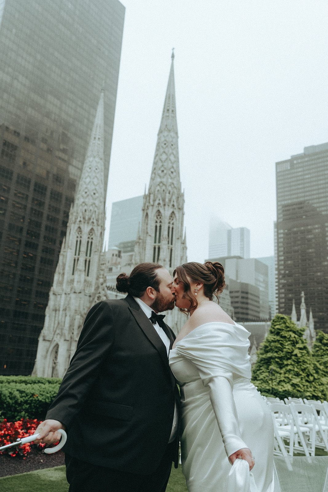 Madison + Dylan 620 Loft and Garden Wedding bride and groom kissing on rooftop at 620 loft & garden wedding, shot by elsie goodman, a destination and NYC wedding photographer